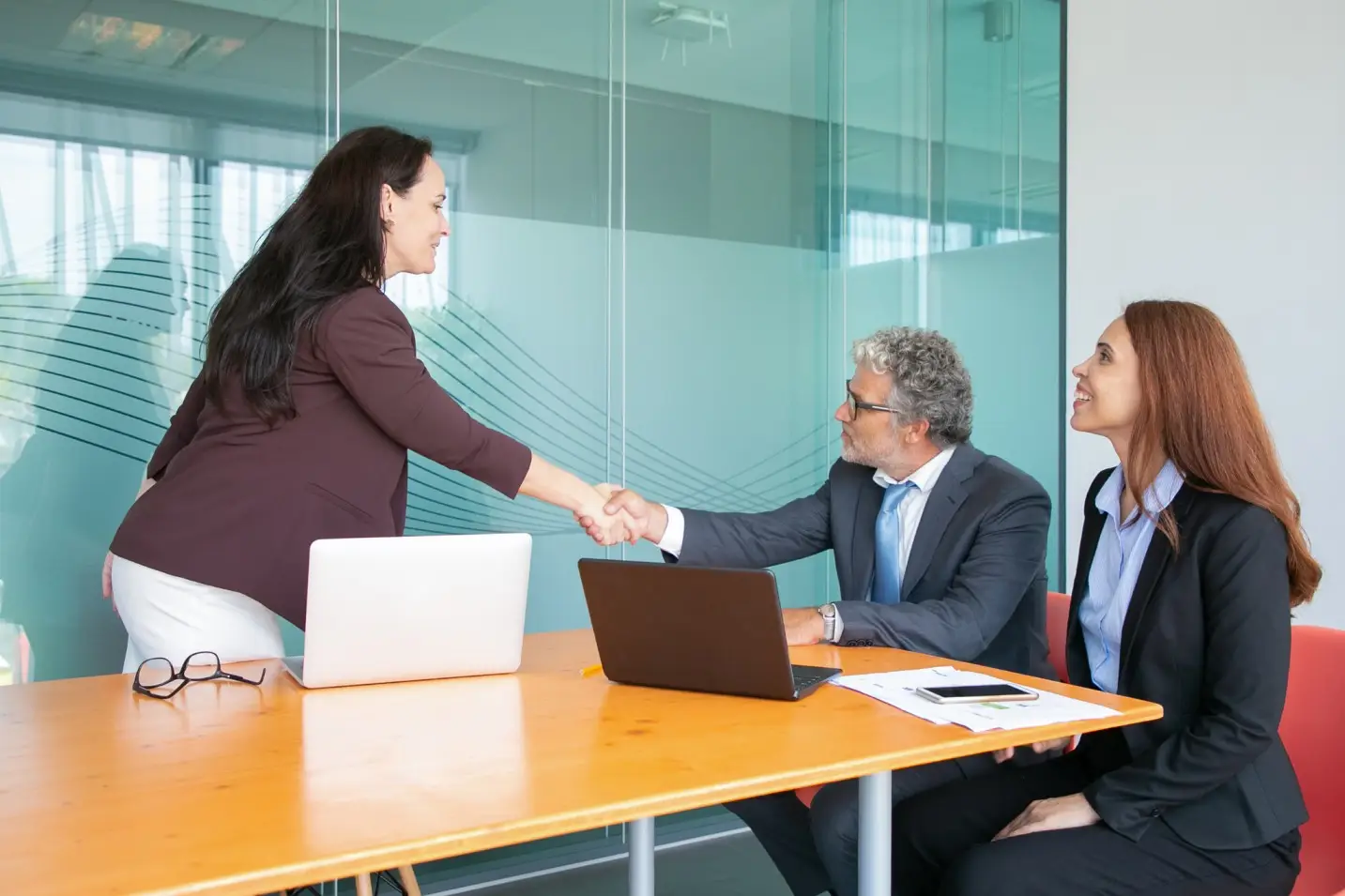 Business acquisition agreement and partnership handshake