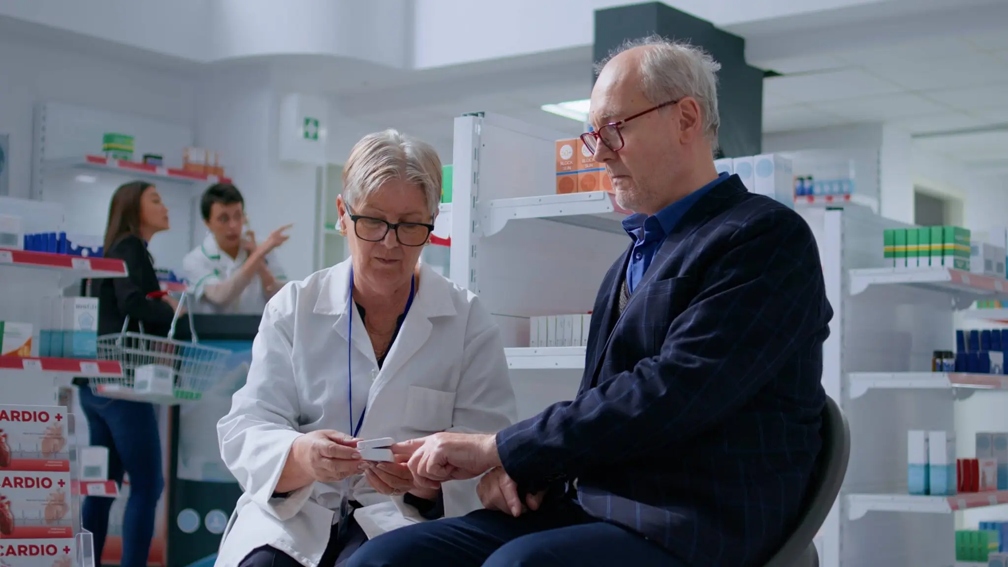 Senior healthcare specialists reviewing practice financials before acquisition