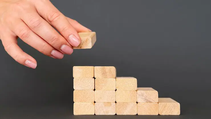 Business growth strategy concept with stacked wooden blocks representing valuation building